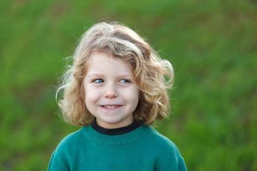 Small child with long blond hair enjoying of a sunny day