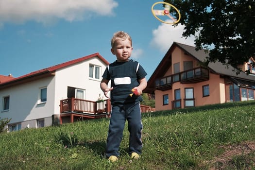 little boy playing with propeller toy