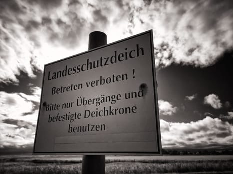 Warning sign on protective dike, Mecklenburg Baltic Sea coast