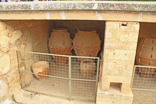 Clay jars or pithoi in the magazine of The Palace of Knossos on Crete in Greece near Heraklion is called Europe’s oldest city and the ceremonial and political center of the Minoan civilization.