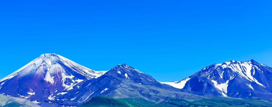 The Avachinsky and Kozelsky volcanoes in Kamchatka in the autumn with a snow-covered top