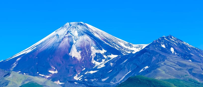 The Avachinsky volcano in Kamchatka in the autumn with a snow-covered top