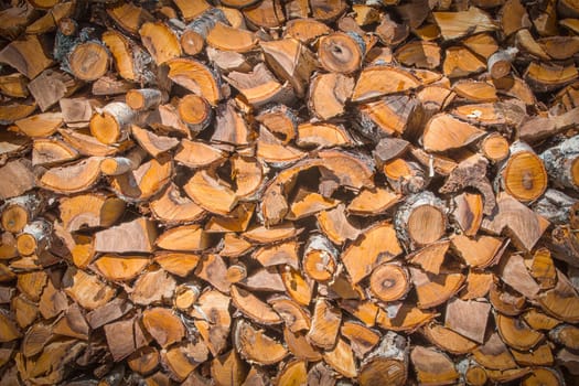 The Chopped and stacked pile of pine and birch wood. Texture, background