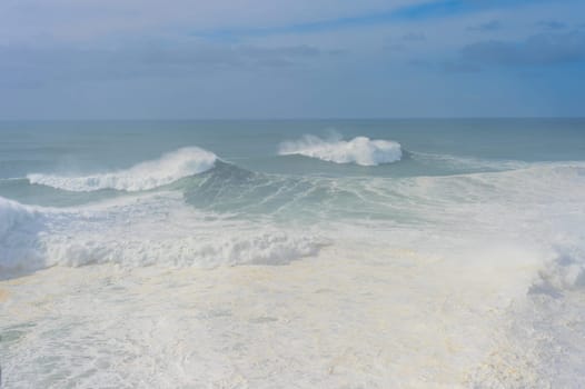 Waves in Atlantic ocean in the mist. Nazare, Portugal