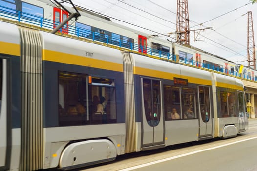 BRUSSELS, BELGIUM - OCTOBER 05, 2019: People at a tram, public train above. Modern public transport of Brussels.