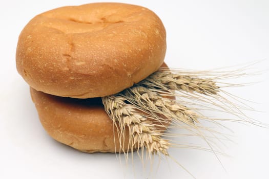 tasty and healthy bread and ripe wheat on white background