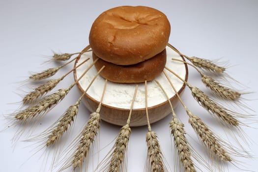 tasty and healthy bread on Atta with ripe wheat on white background