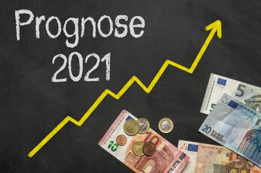 Text on blackboard with money - Forecast 2021 in german - Prognose 2021