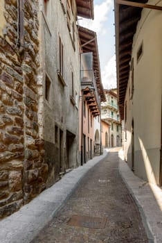 cityscape of historical village  with narrow cobbled street, shot in bright summer light at Gromo, Bergamo, Lombardy, Italy.