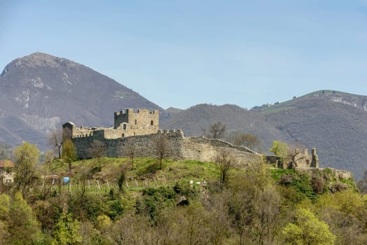 view of ruins of medieval castle set on a hill, shot in bright spring light at Paratico,  Brescia, Lombardy, Italy.