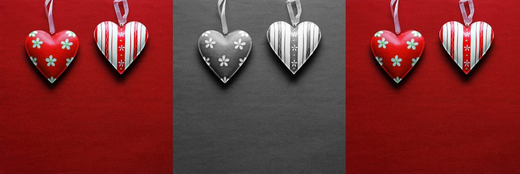 Red and black and white metal hearts on a paper background