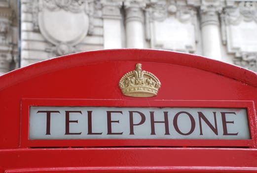 A historic old red telephone box in English London.