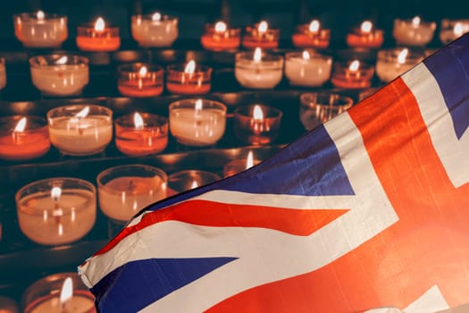 Burning candle and UK flag. The concept of mourning and sorrow in the country, UK national mourning