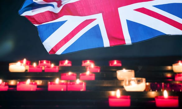 Burning candle and UK flag. The concept of mourning and sorrow in the country, UK national mourning