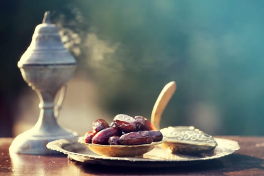 Festive greeting card for Muslim holy month Ramadan Kareem with dates, Quaran and censer