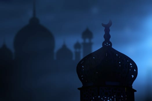 Ramadan Kareem background. Mosque silhouette in the night sky