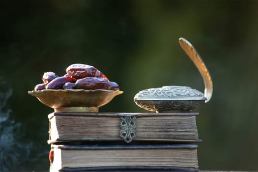 Festive greeting card for Muslim holy month Ramadan Kareem with dates, Quaran and censer
