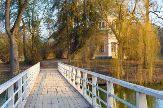 White wooden bridge to the island on a lake in Sofiyivka National Park. Uman, Ukraine