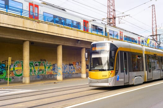 BRUSSELS, BELGIUM - OCTOBER 05, 2019: People at a tram, public train above. Modern public transport of Brussels.