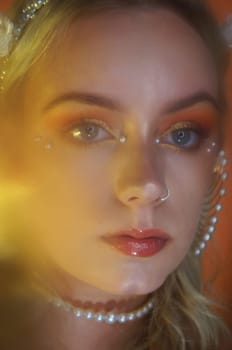 young woman with makeup and pearl jewellery