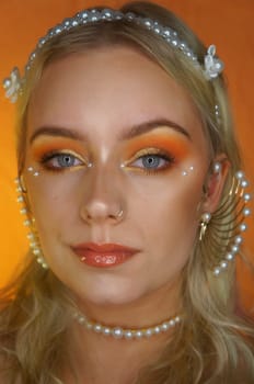 young woman with makeup and pearl jewellery