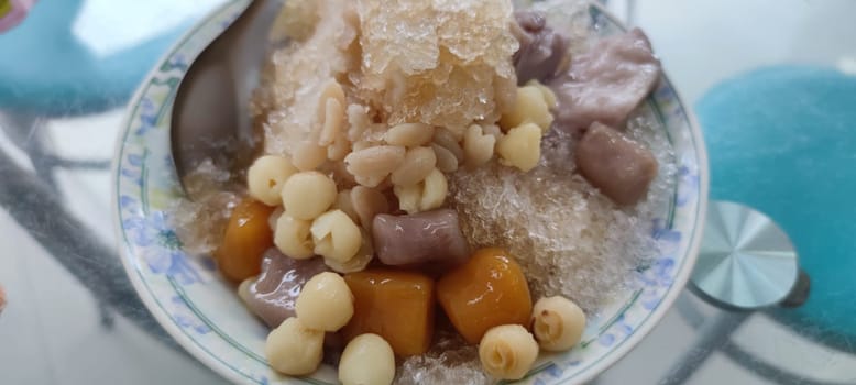 The eating shaved ice with colorful dessert, famous Taiwan snacks