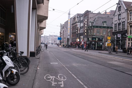 Amsterdam,the Netherlands-December 30,2016:On the street walking people and moving vehicles