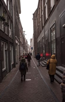 Amsterdam,the Netherlands-December 30,2016:On the street walking people and moving vehicles
