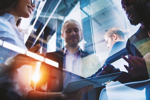 Business people in office connected on internet network with a tablet. concept of startup company. Double exposure