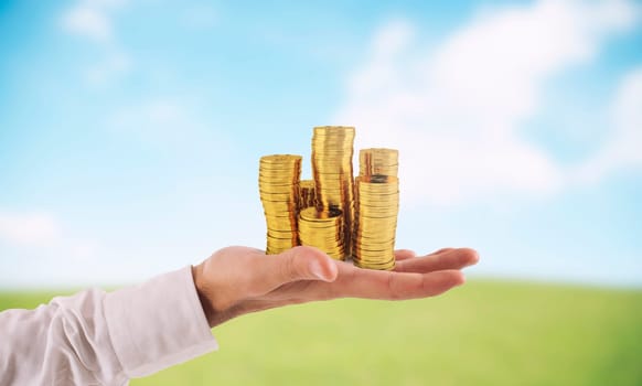 Businessman hold piles of gold money Concept of success and company growth