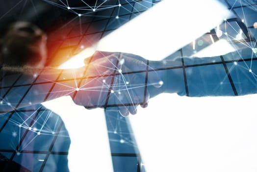 Handshaking business person in the office with network effect. concept of teamwork and partnership. double exposure effect