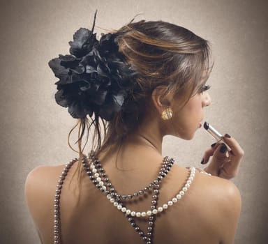 Woman dressed only in strings of pearls