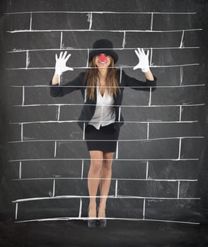 Businesswoman plays to mime imagining a wall