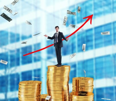 Businessman draws red growing arrow of company statistics over a pile of money