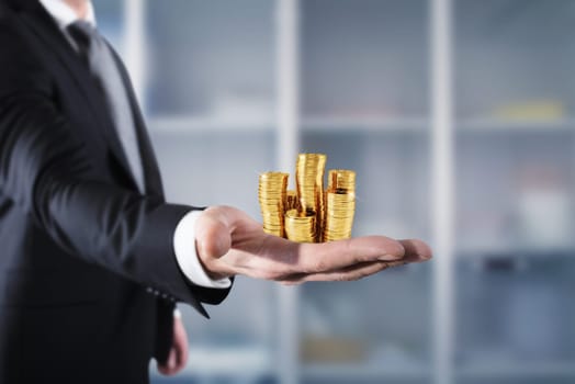 Businessman hold piles of gold money Concept of success and company growth