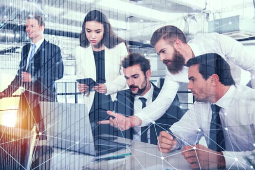 Businessman in office connected on internet network with a computer. concept of startup company. double exposure