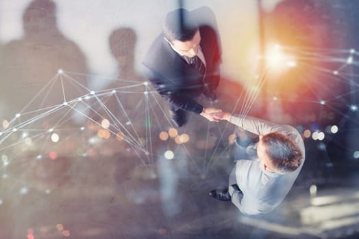 Handshaking business person in the office with network effect. concept of teamwork and business partnership. double exposure
