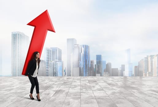 Businesswoman holds a big red arrow. Concept of business growth and success