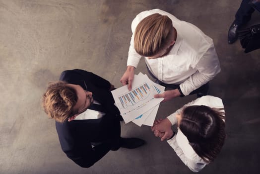Team of people work together in office about company statistics. Concept of teamwork and partnership