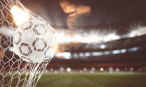 Soccer ball pierces the soccer goal at the stadium during a night match. 3D Rendering