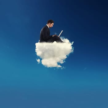 Businessman connected with his laptop over a cloud in the sky. concept of social network and internet addiction
