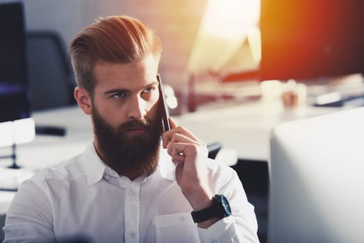 Double exposure of a businessman in a modern office talking to the mobile phone