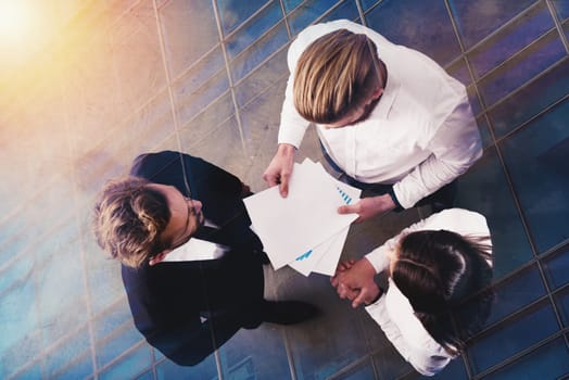 Team of people work together in office about company statistics. Concept of teamwork and partnership. double exposure