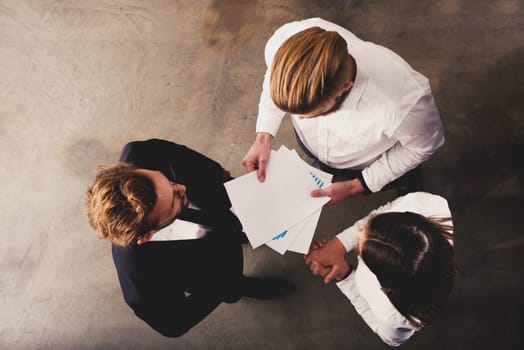Team of people work together in office about company statistics. Concept of teamwork and partnership