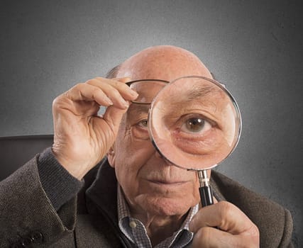 Elder magnifies and tries with magnifying glass