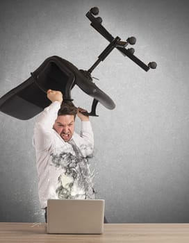 Stressed businessman breaks the computer with chair