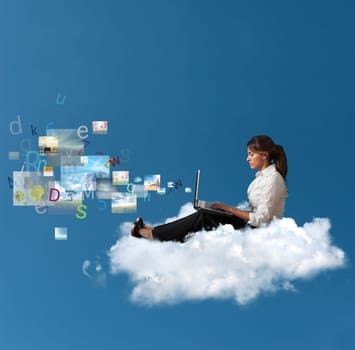 Concept of multimedia with a businesswoman over a cloud with a laptop