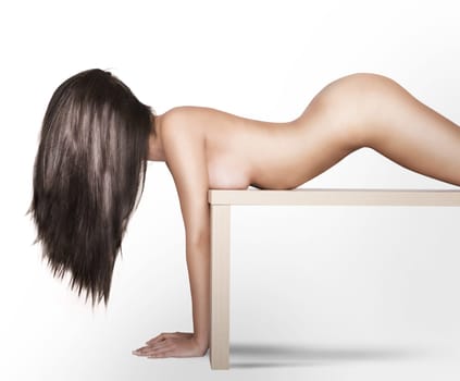 Nude woman model posing on a table