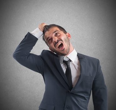 Crazy businessman stressed out from work screams