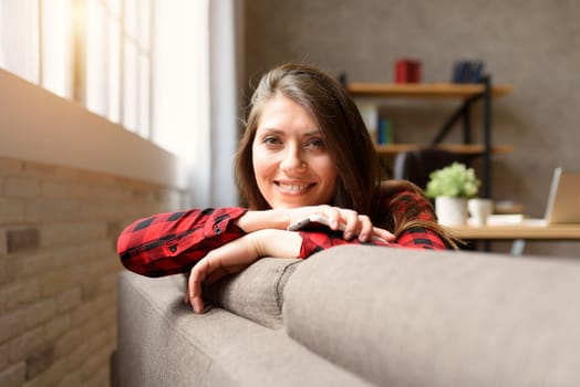 Girl relaxing on a sofa with her smartphone